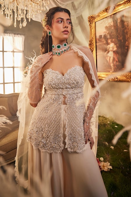 Shop Sunita Bhandari Ivory Tulle, Viscose Cut Work, Diamond Embroidered Peplum Top Sharara Set at Aza Fashions Shop_Sunita Bhandari_Ivory Tulle, Viscose Cut Work, Diamond Embroidered Peplum Top Sharara Set _at_Aza_Fashions