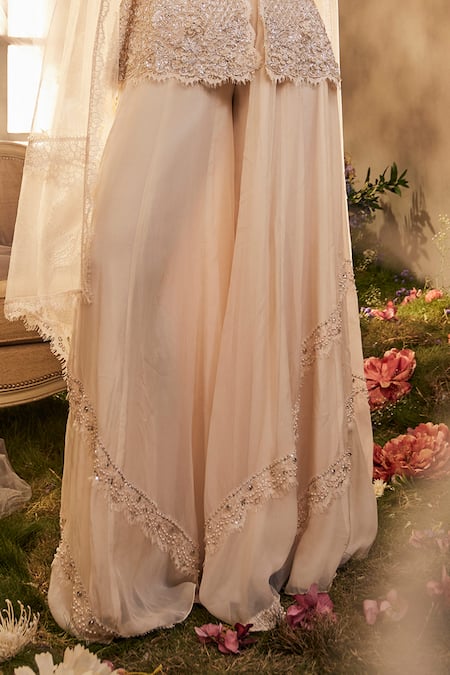 Sunita Bhandari Ivory Tulle, Viscose Cut Work, Diamond Embroidered Peplum Top Sharara Set Online at Aza Fashions Sunita Bhandari_Ivory Tulle, Viscose Cut Work, Diamond Embroidered Peplum Top Sharara Set _Online_at_Aza_Fashions