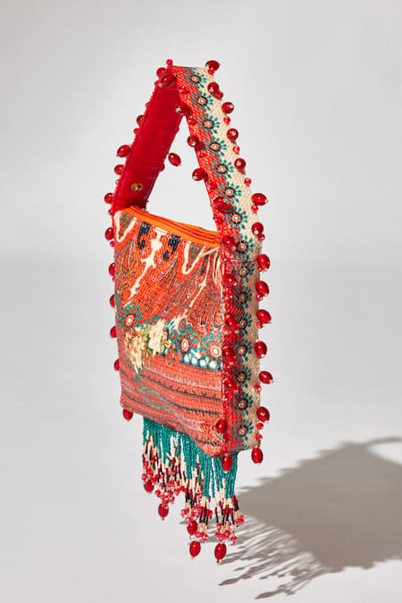 Shop_The Garnish Company_Blue Printed Crisann Floral Tassel Potli _Online_at_Aza_Fashions