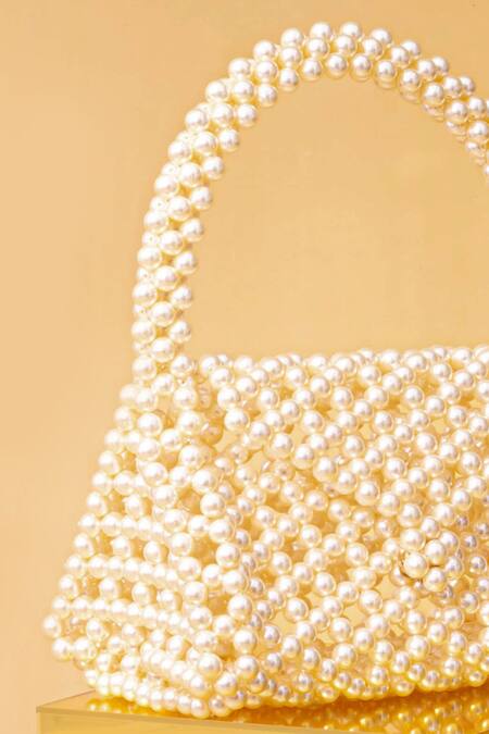 Amyra_Off White Pearls Amelia Triangle Bag_at_Aza_Fashions