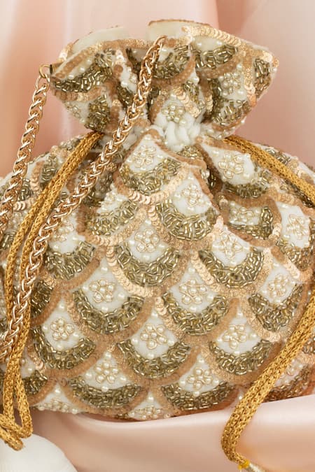 Shop Nayaab By Sonia Ivory Cut Work, Pearls, Sequins Vieira Scallop Grace Embroidered Potli Bag at Aza Fashions Shop_Nayaab By Sonia_Ivory Cut Work, Pearls, Sequins Vieira Scallop Grace Embroidered Potli Bag _at_Aza_Fashions