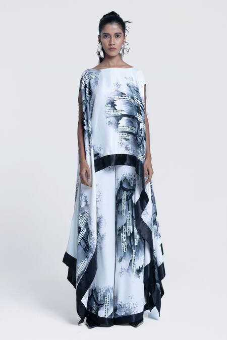 Shop_Pocketful Of Cherrie_White Viscose, Satin Boat Neck Faded Gazette Print Poncho _Online_at_Aza_Fashions