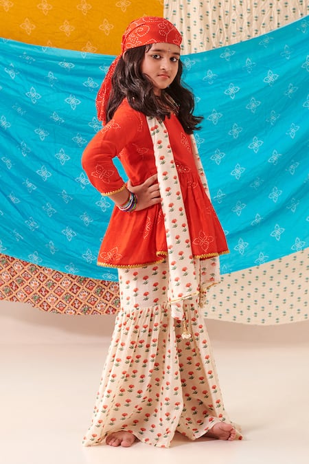 Shop Cute Couture Red Muslin Silk Print Bandhani Bloom Peplum Kurti And Sharara Set at Aza Fashions Shop_Cute Couture_Red Muslin Silk Print Bandhani Bloom Peplum Kurti And Sharara Set _at_Aza_Fashions