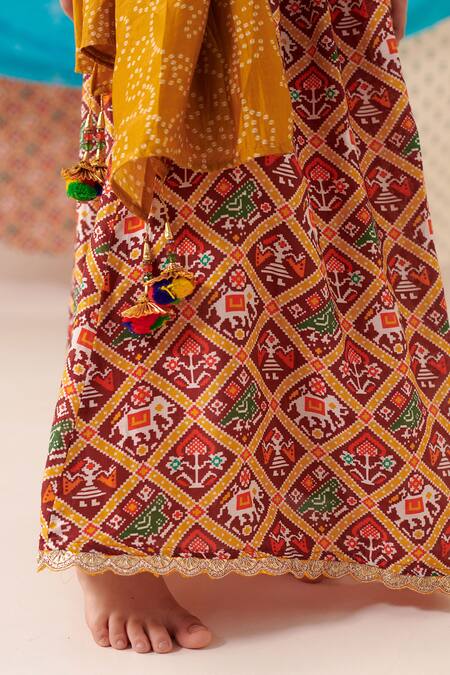 Cute Couture Yellow Silk Print Phool Bloom Blossom Embroidered Top And Patola Lehenga Set at Aza Fashions Cute Couture_Yellow Silk Print Phool Bloom Blossom Embroidered Top And Patola Lehenga Set _at_Aza_Fashions