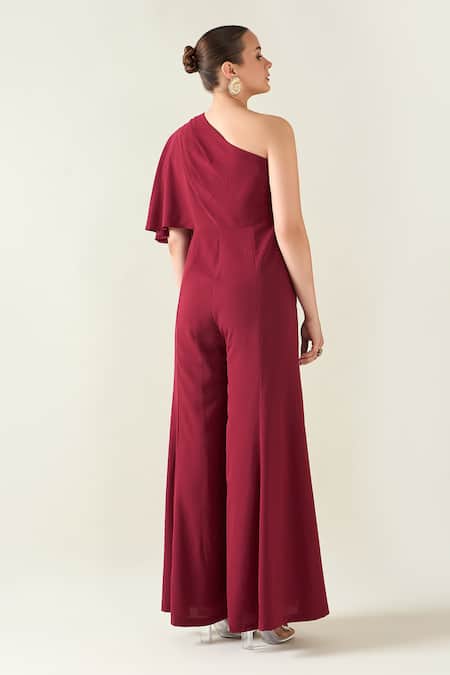 Shop Aakaar Wine Microfiber One Shoulder Alloy Asymmetric Flared Jumpsuit With Metallic Belt at Aza Fashions Shop_Aakaar_Wine Microfiber One Shoulder Alloy Asymmetric Flared Jumpsuit With Metallic Belt _at_Aza_Fashions