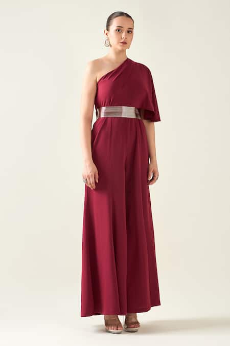 Aakaar Wine Microfiber One Shoulder Alloy Asymmetric Flared Jumpsuit With Metallic Belt Online at Aza Fashions Aakaar_Wine Microfiber One Shoulder Alloy Asymmetric Flared Jumpsuit With Metallic Belt _Online_at_Aza_Fashions