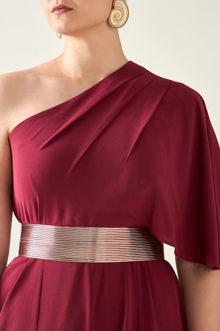 Shop Aakaar Wine Microfiber One Shoulder Alloy Asymmetric Flared Jumpsuit With Metallic Belt Online at Aza Fashions Shop_Aakaar_Wine Microfiber One Shoulder Alloy Asymmetric Flared Jumpsuit With Metallic Belt _Online_at_Aza_Fashions
