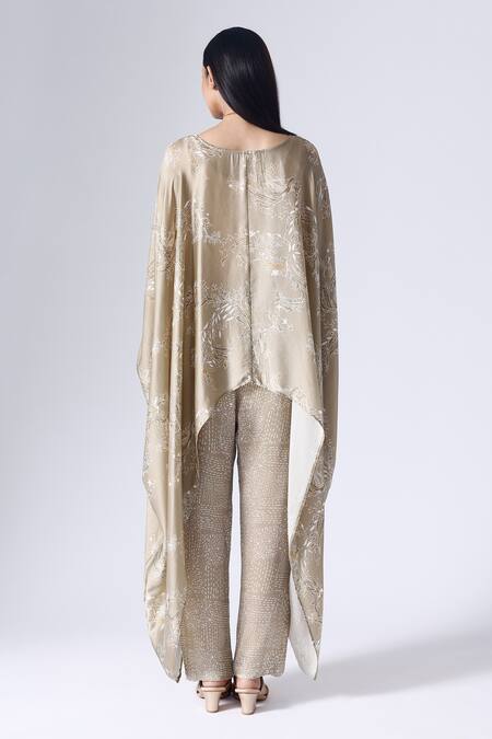 Shop Klad Beige Satin Round Neck Lotus Print Poncho Top And Pant Set at Aza Fashions Shop_Klad_Beige Satin Round Neck Lotus Print Poncho Top And Pant Set_at_Aza_Fashions