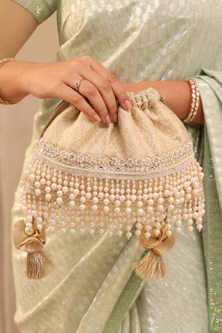 Amyra Ivory Cut Work, Pearls Anahi Tussar Brocade Potli Bag Online at Aza Fashions Amyra_Ivory Cut Work, Pearls Anahi Tussar Brocade Potli Bag _Online_at_Aza_Fashions