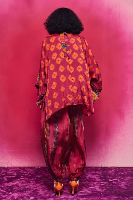 Shop Capisvirleo Fuchsia Silk Tassels, Embroidery Round Ruhi Asymmetric Kurta With Dhoti Pant at Aza Fashions Shop_Capisvirleo_Fuchsia Silk Tassels, Embroidery Round Ruhi Asymmetric Kurta With Dhoti Pant _at_Aza_Fashions