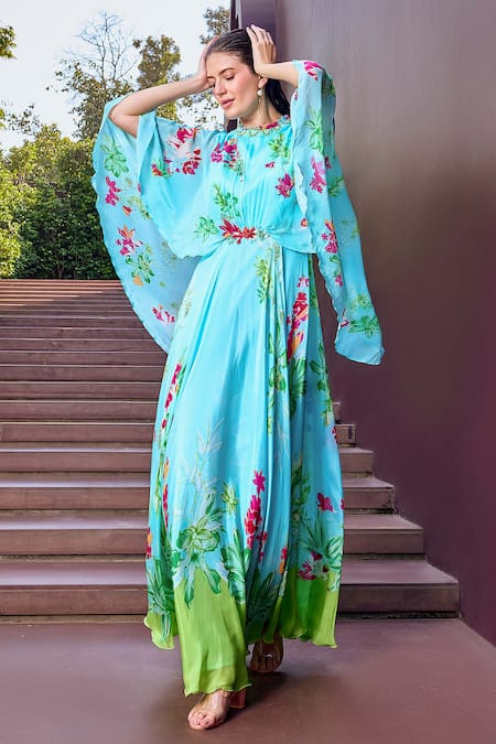 Mandira Wirk Resort Blue Chiffon Round Neck Botanic Bloom Print Cape Sleeves Maxi Dress at Aza Fashions Mandira Wirk Resort_Blue Chiffon Round Neck Botanic Bloom Print Cape Sleeves Maxi Dress _at_Aza_Fashions