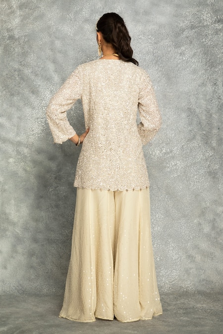 Shop Tanu Malhotra Ivory Net, Organza Sequins, Embroidery, Fringe V-neck Short Kurta And Sharara Set at Aza Fashions Shop_Tanu Malhotra_Ivory Net, Organza Sequins, Embroidery, Fringe V-neck Short Kurta And Sharara Set _at_Aza_Fashions