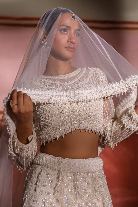 Sabe Ivory Net Pearls, Sequins Round Neck 3d Embroidered Bridal Lehenga Set Online at Aza Fashions Sabe_Ivory Net Pearls, Sequins Round Neck 3d Embroidered Bridal Lehenga Set _Online_at_Aza_Fashions