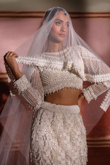Buy Sabe Ivory Net Pearls, Sequins Round Neck 3d Embroidered Bridal Lehenga Set Online at Aza Fashions Buy_Sabe_Ivory Net Pearls, Sequins Round Neck 3d Embroidered Bridal Lehenga Set _Online_at_Aza_Fashions