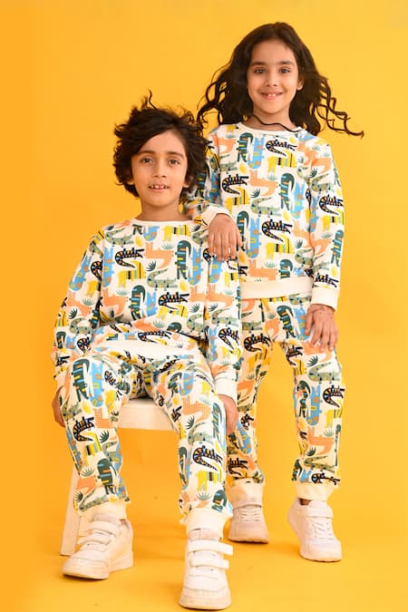 Anthrilo White Fleece Dinosaur Print Sweatshirt And Joggers Set at Aza Fashions Anthrilo_White Fleece Dinosaur Print Sweatshirt And Joggers Set_at_Aza_Fashions