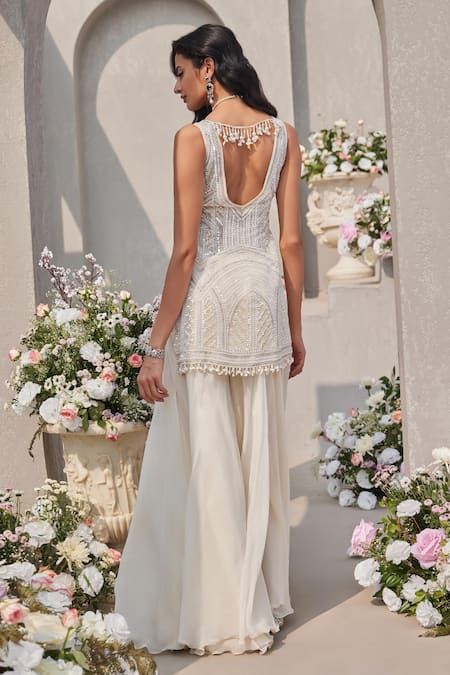 Shop Saisha Ivory Organza Sequins, Cut Work, Tassels, Embellished Peplum Kurta Sharara Set at Aza Fashions Shop_Saisha_Ivory Organza Sequins, Cut Work, Tassels, Embellished Peplum Kurta Sharara Set _at_Aza_Fashions