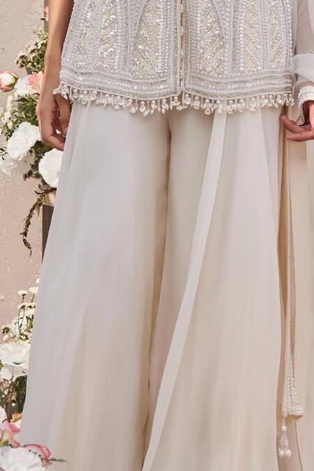 Buy Saisha Ivory Organza Sequins, Cut Work, Tassels, Embellished Peplum Kurta Sharara Set Online at Aza Fashions Buy_Saisha_Ivory Organza Sequins, Cut Work, Tassels, Embellished Peplum Kurta Sharara Set _Online_at_Aza_Fashions