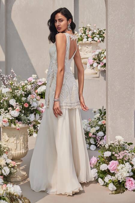 Shop Saisha Ivory Organza Sequins, Cut Work, Tassels, Embellished Peplum Kurta Sharara Set Online at Aza Fashions Shop_Saisha_Ivory Organza Sequins, Cut Work, Tassels, Embellished Peplum Kurta Sharara Set _Online_at_Aza_Fashions