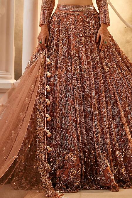 Swish By Dolcy And Simran Rose Gold Net Embroidery, Tassels Asymmetric Nakshi Lehenga Set Online at Aza Fashions Swish By Dolcy And Simran_Rose Gold Net Embroidery, Tassels Asymmetric Nakshi Lehenga Set _Online_at_Aza_Fashions