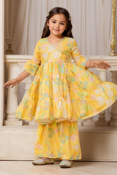 Shop Petite Pomme Yellow Muslin, Net Tassels, Lace, Floral Printed Angarkha And Sharara Set Online at Aza Fashions Shop_Petite Pomme_Yellow Muslin, Net Tassels, Lace, Floral Printed Angarkha And Sharara Set _Online_at_Aza_Fashions