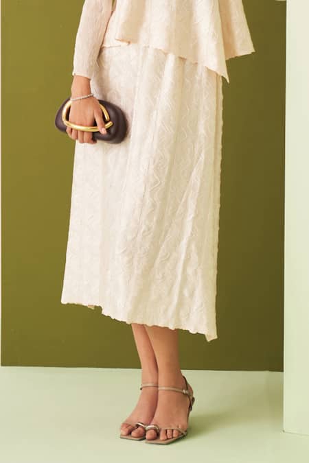 Pleats By Aruni Ivory Crepe, Satin Embroidery Round Neck Textured Asymmetric Top And Skirt Set Online at Aza Fashions Pleats By Aruni_Ivory Crepe, Satin Embroidery Round Neck Textured Asymmetric Top And Skirt Set _Online_at_Aza_Fashions