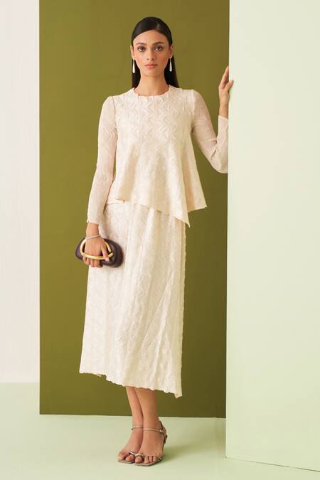 Buy Pleats By Aruni Ivory Crepe, Satin Embroidery Round Neck Textured Asymmetric Top And Skirt Set Online at Aza Fashions Buy_Pleats By Aruni_Ivory Crepe, Satin Embroidery Round Neck Textured Asymmetric Top And Skirt Set _Online_at_Aza_Fashions