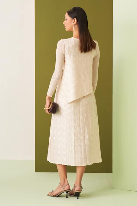 Shop Pleats By Aruni Ivory Crepe, Satin Embroidery Round Neck Textured Asymmetric Top And Skirt Set at Aza Fashions Shop_Pleats By Aruni_Ivory Crepe, Satin Embroidery Round Neck Textured Asymmetric Top And Skirt Set _at_Aza_Fashions