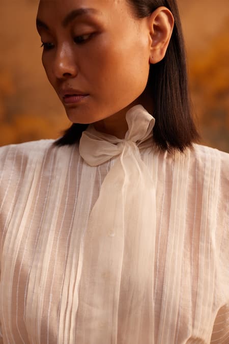 Buy Ahmev Ivory Cotton, Silk Embroidery Turtle Neck Chanderi Pleated Tie-up Shirt Online at Aza Fashions Buy_Ahmev_Ivory Cotton, Silk Embroidery Turtle Neck Chanderi Pleated Tie-up Shirt _Online_at_Aza_Fashions