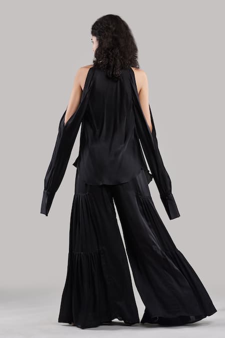 Shop Ituvana Black Silk Plunge Neck Cold Shoulder Top And Flared Pant Set at Aza Fashions Shop_Ituvana_Black Silk Plunge Neck Cold Shoulder Top And Flared Pant Set _at_Aza_Fashions