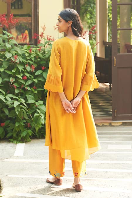 Shop Vaayu Yellow Muslin Applique Round Neck Asymmetric Flared Sleeve Kurta And Pant Set at Aza Fashions Shop_Vaayu_Yellow Muslin Applique Round Neck Asymmetric Flared Sleeve Kurta And Pant Set _at_Aza_Fashions