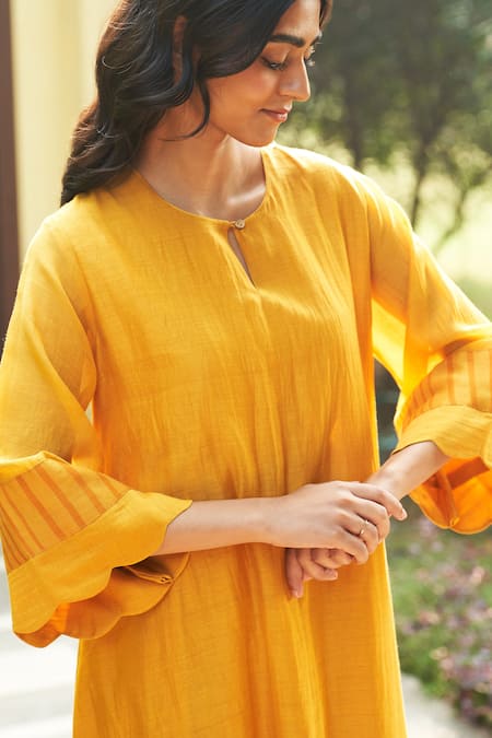 Buy Vaayu Yellow Muslin Applique Round Neck Asymmetric Flared Sleeve Kurta And Pant Set Online at Aza Fashions Buy_Vaayu_Yellow Muslin Applique Round Neck Asymmetric Flared Sleeve Kurta And Pant Set _Online_at_Aza_Fashions