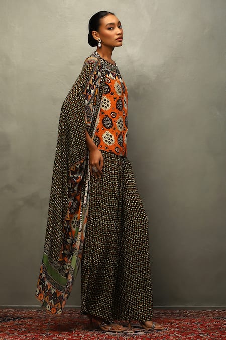 Shop RI.Ritu Kumar Black Viscose Mirrors, Embroidery Tribal Bloom Print Cape And Flared Pant Set Online at Aza Fashions Shop_RI.Ritu Kumar_Black Viscose Mirrors, Embroidery Tribal Bloom Print Cape And Flared Pant Set _Online_at_Aza_Fashions