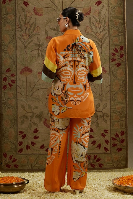 Shop Sva By Sonam & Paras Modi Orange Crepe Collared Mask Print Top And Pant Set at Aza Fashions Shop_Sva By Sonam & Paras Modi_Orange Crepe Collared Mask Print Top And Pant Set_at_Aza_Fashions