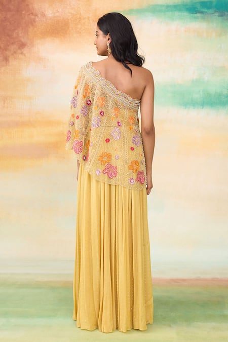 Shop SHASHA GABA Yellow Organza, Muslin Embroidery One Shoulder Cape Top And Skirt Set at Aza Fashions Shop_SHASHA GABA_Yellow Organza, Muslin Embroidery One Shoulder Cape Top And Skirt Set _at_Aza_Fashions