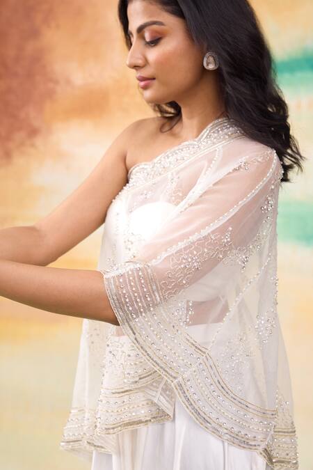 SHASHA GABA Ivory Organza, Modal Cut Work Round Neck Ditsy Embroidered One Shoulder Cape Set at Aza Fashions SHASHA GABA_Ivory Organza, Modal Cut Work Round Neck Ditsy Embroidered One Shoulder Cape Set _at_Aza_Fashions