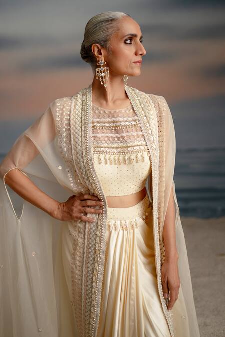 Shashank Arya Ivory Organza, Satin, Lycra Pearls, Seashell Embellished Cape Dhoti Skirt Set at Aza Fashions Shashank Arya_Ivory Organza, Satin, Lycra Pearls, Seashell Embellished Cape Dhoti Skirt Set _at_Aza_Fashions