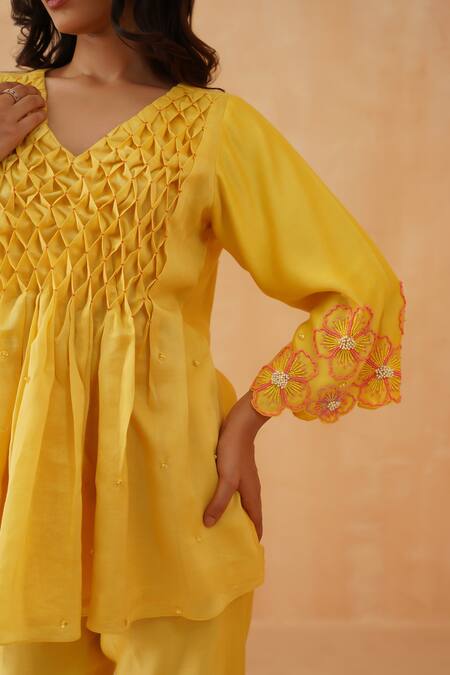 Rishika Singh_Yellow Chanderi Beads, Embroidery V-neck Honeycomb Smocked Peplum Kurta Set _at_Aza_Fashions