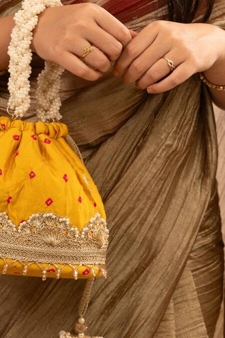 Buy Amyra Yellow Lace, Pearls Embellished Bandhani Bucket Bag Online at Aza Fashions Buy_Amyra_Yellow Lace, Pearls Embellished Bandhani Bucket Bag _Online_at_Aza_Fashions