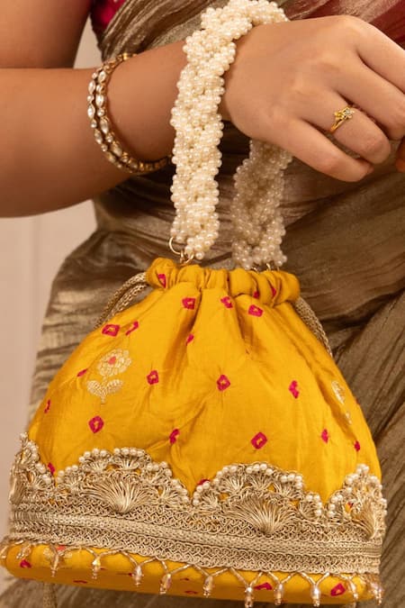 Shop Amyra Yellow Lace, Pearls Embellished Bandhani Bucket Bag at Aza Fashions Shop_Amyra_Yellow Lace, Pearls Embellished Bandhani Bucket Bag _at_Aza_Fashions