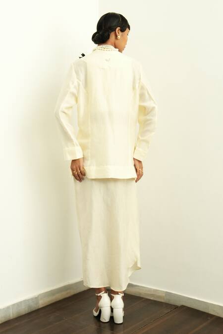 Shop OFRIDA Ivory Silk Applique V-neck 3d Rose Jacket And Draped Skirt Set at Aza Fashions Shop_OFRIDA_Ivory Silk Applique V-neck 3d Rose Jacket And Draped Skirt Set_at_Aza_Fashions