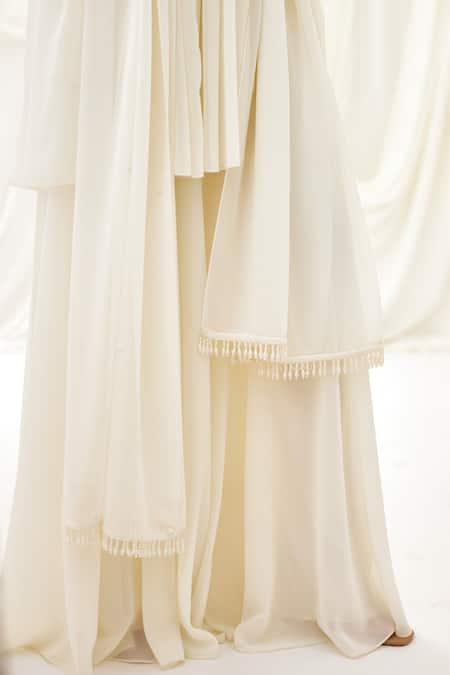 Lavanya Ahuja Ivory Georgette Pearls, Tassels Collared Embroidered Peplum Tunic Sharara Set Online at Aza Fashions Lavanya Ahuja_Ivory Georgette Pearls, Tassels Collared Embroidered Peplum Tunic Sharara Set _Online_at_Aza_Fashions
