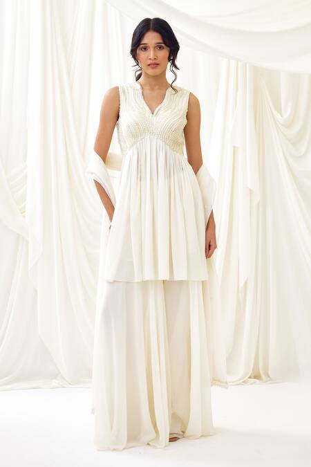 Buy Lavanya Ahuja Ivory Georgette Pearls, Tassels Collared Embroidered Peplum Tunic Sharara Set Online at Aza Fashions Buy_Lavanya Ahuja_Ivory Georgette Pearls, Tassels Collared Embroidered Peplum Tunic Sharara Set _Online_at_Aza_Fashions