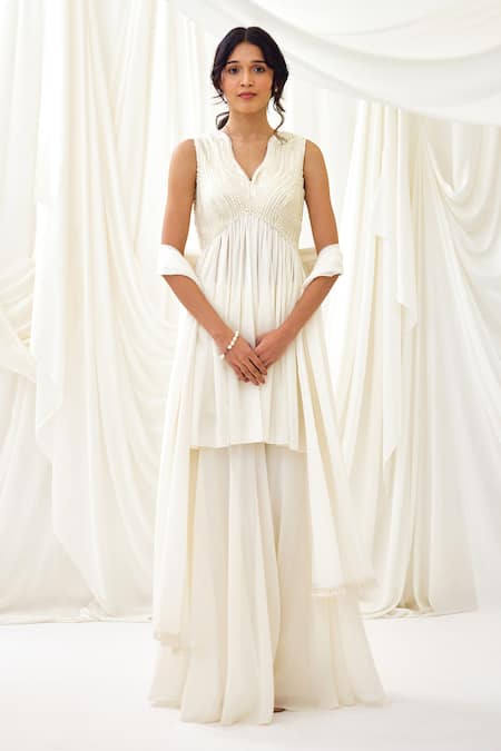 Shop Lavanya Ahuja Ivory Georgette Pearls, Tassels Collared Embroidered Peplum Tunic Sharara Set Online at Aza Fashions Shop_Lavanya Ahuja_Ivory Georgette Pearls, Tassels Collared Embroidered Peplum Tunic Sharara Set _Online_at_Aza_Fashions