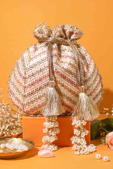 Shop Amyra Off White Embroidery, Tassels, Pearls Chevron Potli Bag at Aza Fashions Shop_Amyra_Off White Embroidery, Tassels, Pearls Chevron Potli Bag _at_Aza_Fashions
