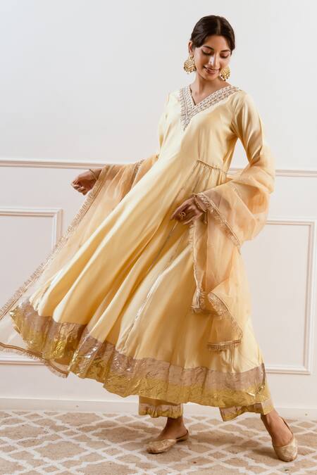 Buy Rivaaj Clothing Beige Modal, Silk Gota Patti, Sequins, Zari V-neck Embroidered Anarkali Set Online at Aza Fashions Buy_Rivaaj Clothing_Beige Modal, Silk Gota Patti, Sequins, Zari V-neck Embroidered Anarkali Set _Online_at_Aza_Fashions