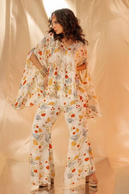 Buy Label Shristi Chetani White Satin Floral Printed Cape Top And Flare Pants Set Online at Aza Fashions Buy_Label Shristi Chetani_White Satin Floral Printed Cape Top And Flare Pants Set_Online_at_Aza_Fashions