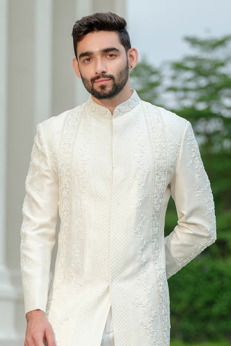 Shop Niloufer By Aasif Ally Ivory Silk Cut Work Cutdana Sherwani And Trouser Set at Aza Fashions Shop_Niloufer By Aasif Ally_Ivory Silk Cut Work Cutdana Sherwani And Trouser Set _at_Aza_Fashions