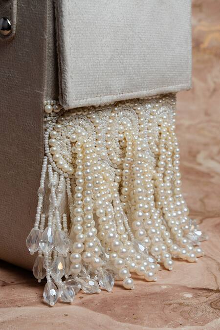 Shop Nayaab By Sonia Ivory Pearls, Crystals Tassel Potli Clutch Online at Aza Fashions Shop_Nayaab By Sonia_Ivory Pearls, Crystals Tassel Potli Clutch_Online_at_Aza_Fashions