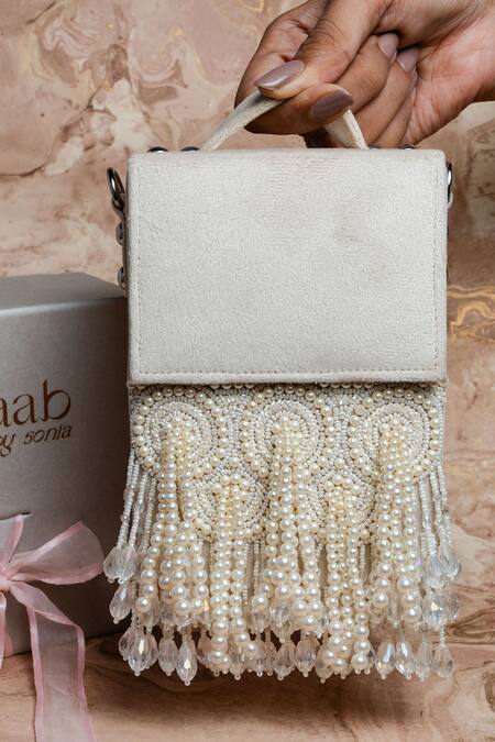 Shop Nayaab By Sonia Ivory Pearls, Crystals Tassel Potli Clutch at Aza Fashions Shop_Nayaab By Sonia_Ivory Pearls, Crystals Tassel Potli Clutch_at_Aza_Fashions