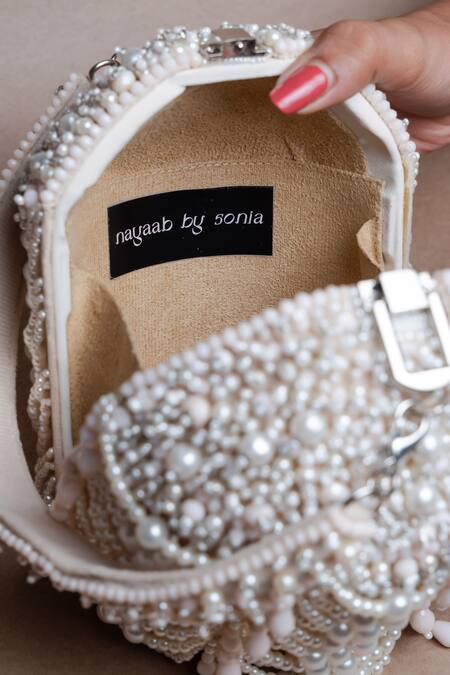Buy Nayaab By Sonia Off White Pearls, Tassels Oyster Overload Embellished Potli Online at Aza Fashions Buy_Nayaab By Sonia_Off White Pearls, Tassels Oyster Overload Embellished Potli _Online_at_Aza_Fashions